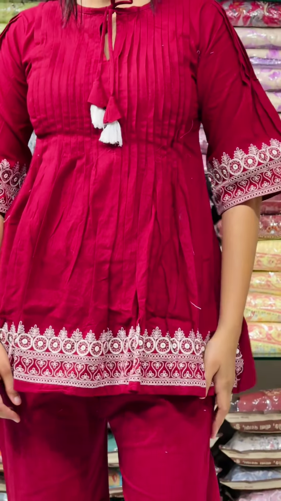 Women’s Red Embroidered Kurti Pant Set – White Threadwork Details with Boutique Shelf Backdrop - Image 2