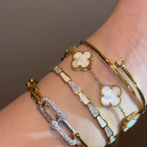 Luxurious Layered Gold-Toned Bracelet Stack with Clover, Pave, and Nail Designs